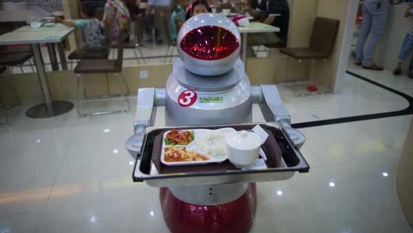 This photo taken on August 13, 2014, shows a robot carrying food to customers in a restaurant in Kunshan. It's more teatime than Terminator -- a restaurant in China is electrifying customers by using more than a dozen robots to cook and deliver food - Sputnik International