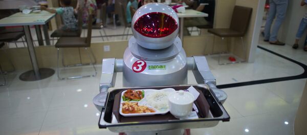 This photo taken on August 13, 2014, shows a robot carrying food to customers in a restaurant in Kunshan. It's more teatime than Terminator -- a restaurant in China is electrifying customers by using more than a dozen robots to cook and deliver food - Sputnik International
