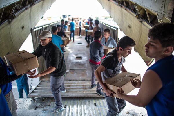 Unloading Russian EMERCOM plane with humanitarian aid which arrived to Latakia Airport in Syria. File photo Unloading Russian EMERCOM plane with humanitarian aid which arrived to Latakia Airport in Syria. File photo - Sputnik International