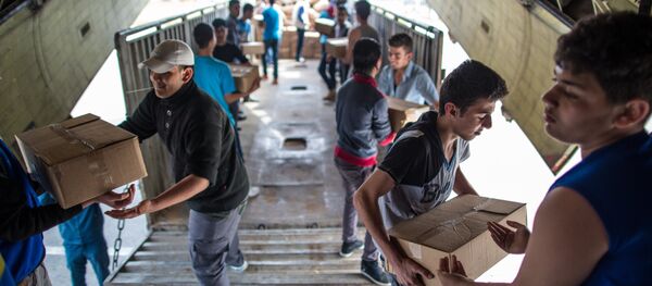 Unloading Russian EMERCOM plane with humanitarian aid which arrived to Latakia Airport in Syria. File photo - Sputnik International