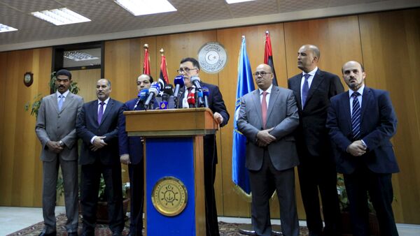 Libyan prime minister-designate under a proposed National Unity government Fayez Seraj (C) attends a news conference in Tripoli, Libya, March 30, 2016 - Sputnik International