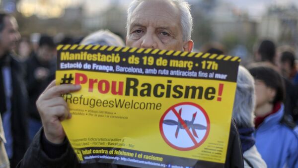 A protester called by Stop Mare Mortum and “Unity against Fascism and Racism” platforms, holds a poster reading Stop Racism in Catalan during the European March for Refugee Rights in Barcelona on March 19, 2016. - Sputnik International