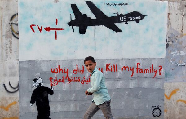 A Yemeni boy (C) walks past a mural depicting a US drone and reading Why did you kill my family on December 13, 2013 in the capital Sanaa. A Yemeni boy (C) walks past a mural depicting a US drone and reading Why did you kill my family on December 13, 2013 in the capital Sanaa. - Sputnik International