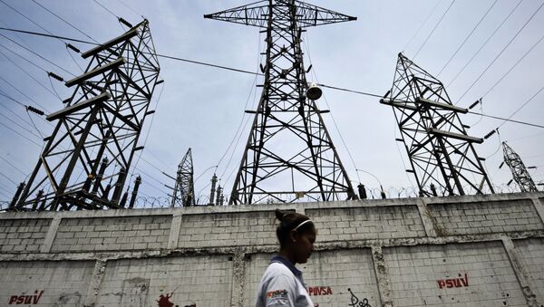 A woman walks in front of electricity pylons in Caracas, Venezuela (File) - Sputnik International