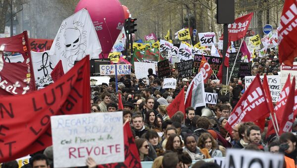 Demonstrators hold banners and signs during a protest on April 9, 2016 at the Place de la Bastille in Paris, against the French government's proposed labour law reforms - Sputnik International