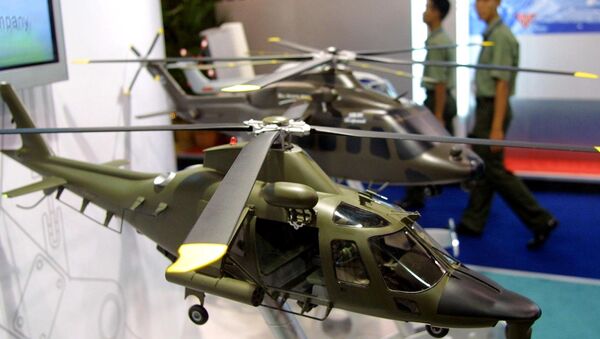 Army personnels walk past models of combat helicopters on display at the Defense Services Asia exhibition in Kuala Lumpur. (File) - Sputnik International
