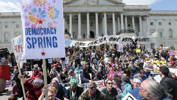 Voting rights reform demonstrators stage a sit-in at the Capitol in Washington, Monday, April 11, 2016, urging lawmakers to take money out of the political process. - Sputnik International