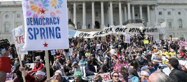 Voting rights reform demonstrators stage a sit-in at the Capitol in Washington, Monday, April 11, 2016, urging lawmakers to take money out of the political process. Voting rights reform demonstrators stage a sit-in at the Capitol in Washington, Monday, April 11, 2016, urging lawmakers to take money out of the political process. - Sputnik International