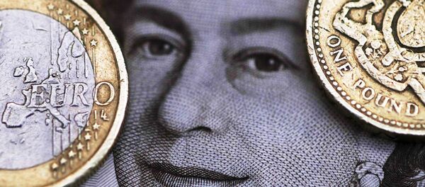 A two Euro coin is pictured next to a one Pound coin on top of a portrait of Britain's Queen Elizabeth in this file photo illustration shot March 16, 2016. - Sputnik International