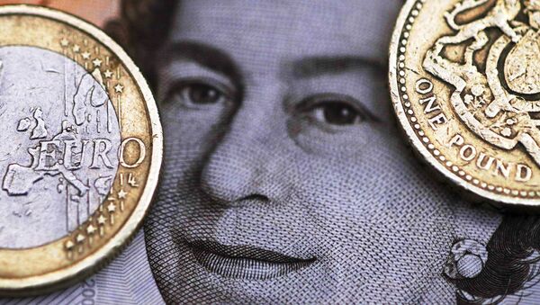 A two Euro coin is pictured next to a one Pound coin on top of a portrait of Britain's Queen Elizabeth in this file photo illustration shot March 16, 2016. - Sputnik International
