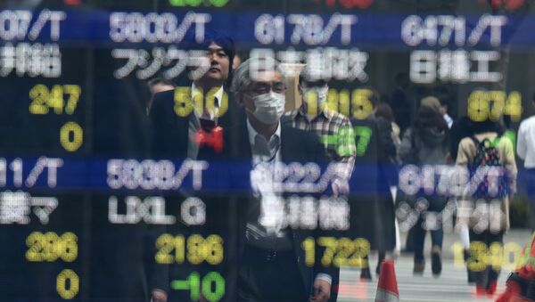 Pedestrians are reflected on an electronic stock quotation board at the window of a securities company in Tokyo on April 8, 2016 - Sputnik International