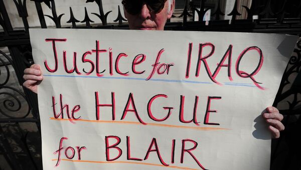 An anti-war protester holds a placard that reads Justice for Iraq, the Hague for Blair during a demonstration outside the High Court in central London on May 28, 2012. - Sputnik International
