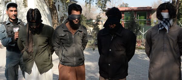 Alleged fighters for Islamic State (IS) stand handcuffed while being presented to the media at a police headquarter in Jalalabad (File) - Sputnik International