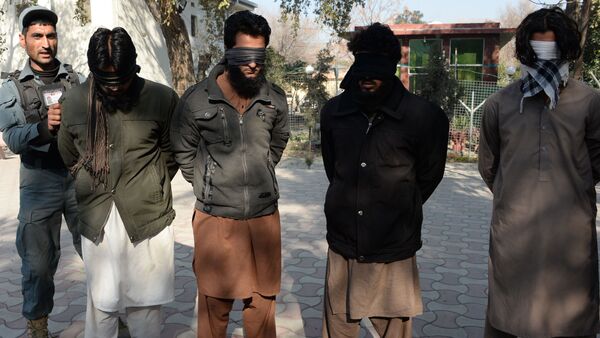 Alleged fighters for Islamic State (IS) stand handcuffed while being presented to the media at a police headquarter in Jalalabad (File) - Sputnik International