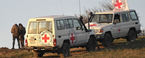 Vehicles of the representatives of the International Committee of the Red Cross on the demarcation line where a search is being conducted for the bodies of the victims Vehicles of the representatives of the International Committee of the Red Cross on the demarcation line where a search is being conducted for the bodies of the victims - Sputnik International