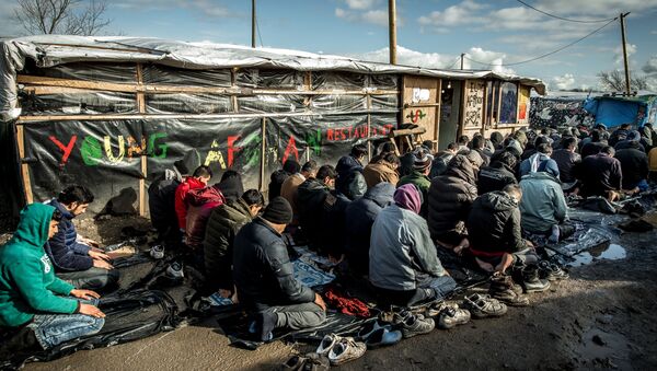 Men pray  in the migrants and refugee camp in Calais, northern France. File photo - Sputnik International