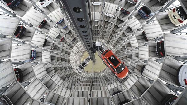 A VW Golf VII car (R) and a VW Passat are loaded in a delivery tower at the plant of German carmaker Volkswagen in Wolfsburg, Germany in this March 3, 2015 - Sputnik International