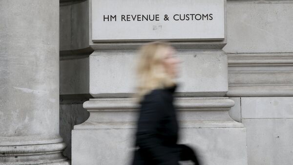A pedestrian walks past the headquarters of Her Majesty's Revenue and Customs (HMRC) in central London, Britain in this February 13, 2015 file photo - Sputnik International