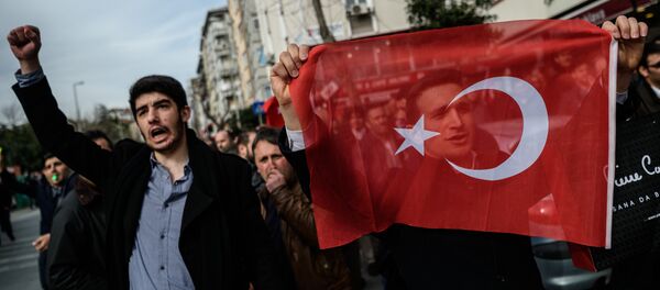 A protester holds a Turkish flag during a demonstration near the headquarters of the newspaper Zaman in Istanbul on March 6, 2016. - Sputnik International