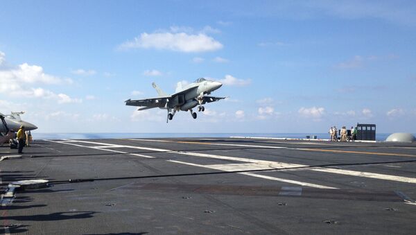F-18 jet fighter takes off on the USS John C. Stennis, aircraft carrier in the South China Sea on Friday, April 15, 2016. U.S. Defense Secretary Ash Carter visited the aircraft carrier during a trip to the region - Sputnik International