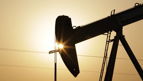 An oil pump works at sunset Wednesday, Sept. 30, 2015, in the desert oil fields of Sakhir, Bahrain - Sputnik International