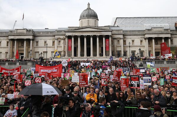 Protesters with placards and banners demonstrating on a variety of domestic issues including a call for British Prime Minister David Cameron to stand down, organised by the People’s Assembly Against Austerity, listen to speeches in Trafalgar Square after marching in central London on April 16, 2016.  - Sputnik International