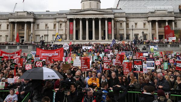 Protesters with placards and banners demonstrating on a variety of domestic issues including a call for British Prime Minister David Cameron to stand down, organised by the People’s Assembly Against Austerity, listen to speeches in Trafalgar Square after marching in central London on April 16, 2016. - Sputnik International