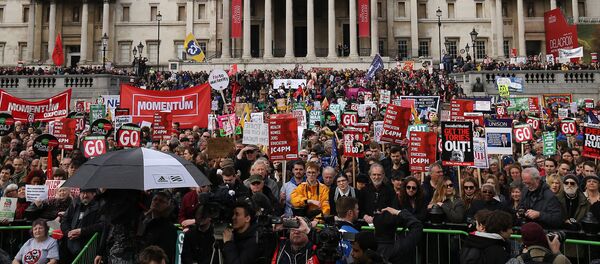 Protesters with placards and banners demonstrating on a variety of domestic issues including a call for British Prime Minister David Cameron to stand down, organised by the People’s Assembly Against Austerity, listen to speeches in Trafalgar Square after marching in central London on April 16, 2016. - Sputnik International