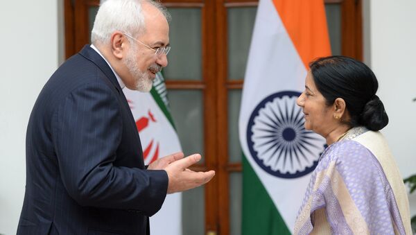 Indian Foreign Minister Sushma Swaraj (R) looks towards Iran's Foreign Minister Javad Zarif as they greet each other ahead of a meeting in New Delhi - Sputnik International