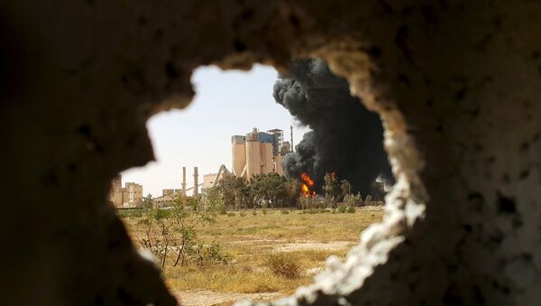 A fire is seen next to the Libyan cement factory - Sputnik International