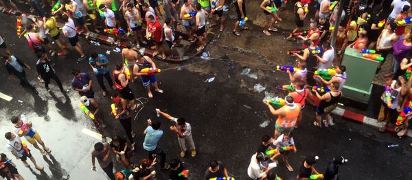 Revelers douse each other with water during the Songkran water festival on Silom road in Bangkok, Thailand Revelers douse each other with water during the Songkran water festival on Silom road in Bangkok, Thailand - Sputnik International