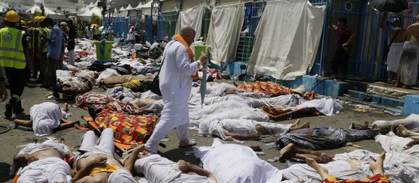 Muslim pilgrim walks through the site where dead bodies are gathered after a stampede during the annual hajj pilgrimage, in Mina, Saudi Arabia. (File) Muslim pilgrim walks through the site where dead bodies are gathered after a stampede during the annual hajj pilgrimage, in Mina, Saudi Arabia. (File) - Sputnik International