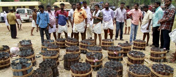 People stand next to empty fire cracker shells inside the compound of a temple after a fire broke out at the temple in Kollam in the southern state of Kerala, India, April 10, 2016. People stand next to empty fire cracker shells inside the compound of a temple after a fire broke out at the temple in Kollam in the southern state of Kerala, India, April 10, 2016. - Sputnik International
