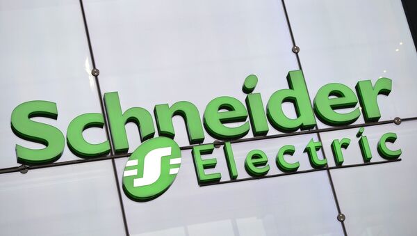 The logo of electricity distribution and energy management group Schneider Electric at the company's headquarters in Rueil-Malmaison, outside Paris - Sputnik International