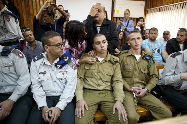 The father (C, back) of Israeli soldier Elor Azaria (C, seated), who is charged with manslaughter by the Israeli military. The father (C, back) of Israeli soldier Elor Azaria (C, seated), who is charged with manslaughter by the Israeli military. - Sputnik International