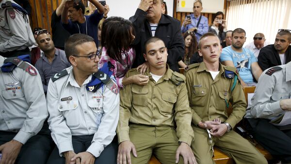 The father (C, back) of Israeli soldier Elor Azaria (C, seated), who is charged with manslaughter by the Israeli military - Sputnik International