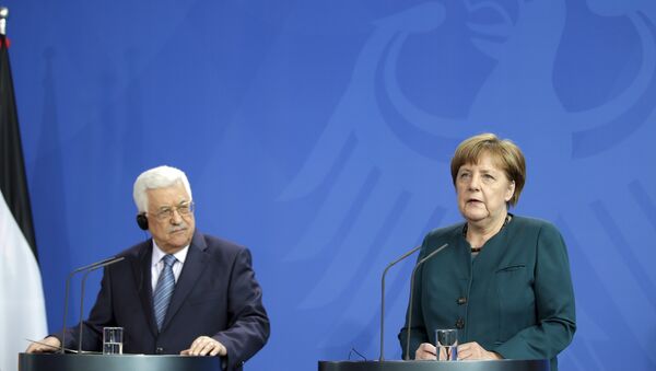 German Chancellor Angela Merkel, right, and Palestinian President Mahmoud Abbas, left, address the media during a joint news conference as part of a meeting at the chancellery in Berlin, Germany, Tuesday, April 19, 2016. - Sputnik International