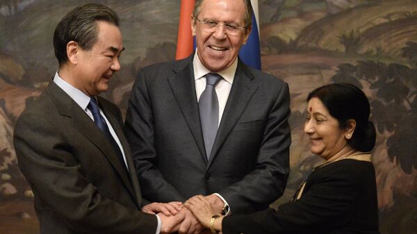 From left: Chinese Foreign Minister Wang Yi, Russian Foreign Minister Sergei Lavrov and Indian Foreign Minister Sushma Swaraj during are photographed before a plenary meeting of the foreign ministers of Russia, India and China (RIC) in the Reception House of the Russian Foreign Ministry. - Sputnik International