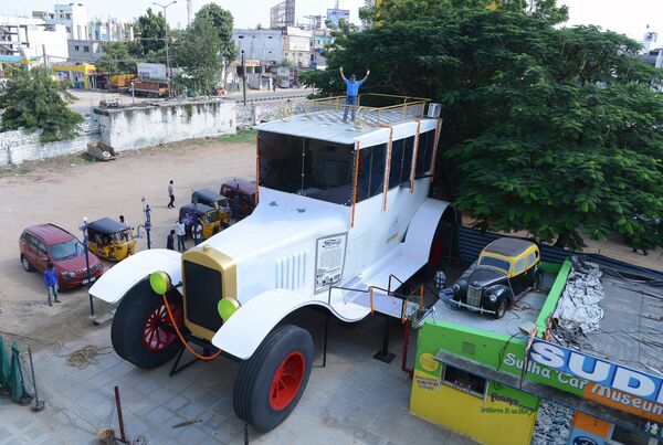 Indian car designer Sudhakar Yadav poses on the top of a large stationary car -- modelled on the 1922 Ford Tourer -- at the Sudha Cars Museum in Hyderabad - Sputnik International