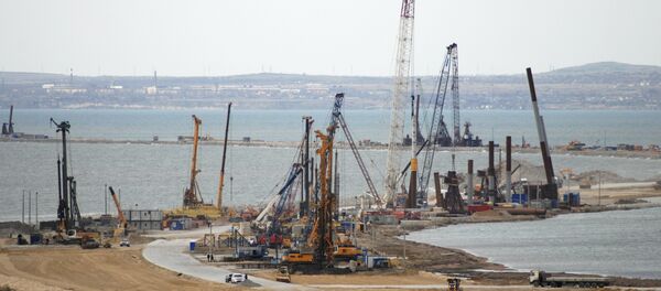 The construction of a bridge across the Kerch Strait to Crimea is seen from the outskirts of the Taman settlement in Krasnodar region, southern Russia, April 4, 2016 - Sputnik International