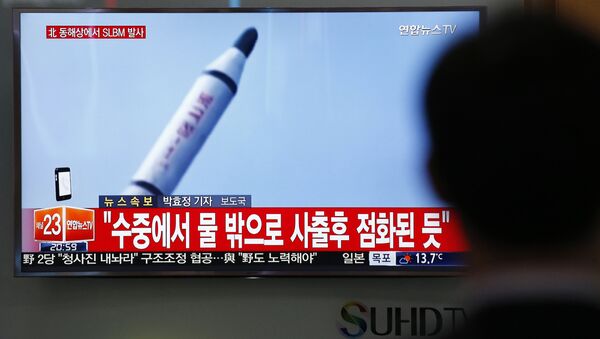 A file photo of a man as he watches a TV news program showing a file footage of a missile launch conducted by North Korea, at the Seoul Train Station in Seoul, South Korea, Saturday, April 23, 2016 - Sputnik International