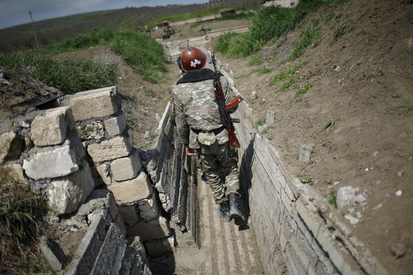 Ethnic Armenian soldiers walk in a trench at their position near Nagorno-Karabakh's town of Martuni, April 8, 2016 Ethnic Armenian soldiers walk in a trench at their position near Nagorno-Karabakh's town of Martuni, April 8, 2016 - Sputnik International