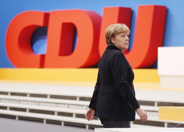 German Chancellor Angela Merkel walks past the party logo during a party convention of the Christian Democrats (CDU) in Karlsruhe, Germany, December 14, 2015. - Sputnik International