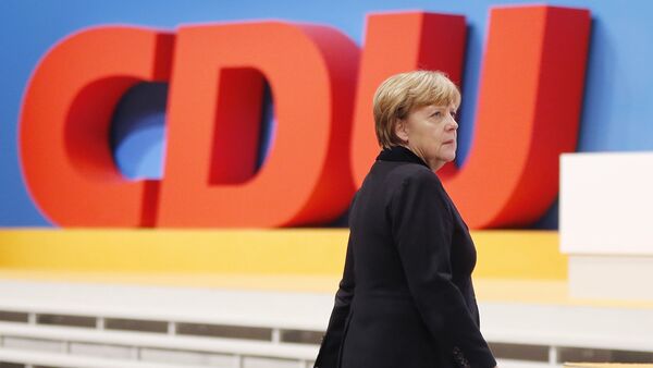 German Chancellor Angela Merkel walks past the party logo during a party convention of the Christian Democrats (CDU) in Karlsruhe, Germany, December 14, 2015. - Sputnik International