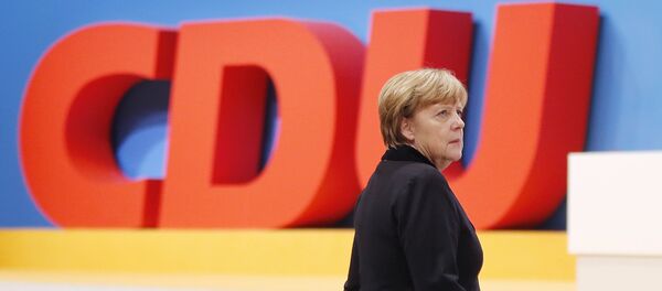 German Chancellor Angela Merkel walks past the party logo during a party convention of the Christian Democrats (CDU) in Karlsruhe, Germany, December 14, 2015. German Chancellor Angela Merkel walks past the party logo during a party convention of the Christian Democrats (CDU) in Karlsruhe, Germany, December 14, 2015. - Sputnik International