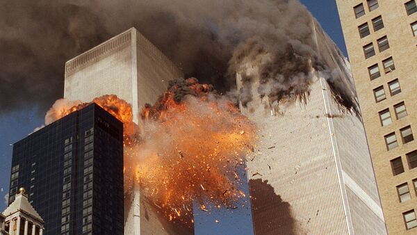 Smoke billows from one of the towers of the World Trade Center and flames and debris explode from the second tower, Tuesday, Sept. 11, 2001 - Sputnik International