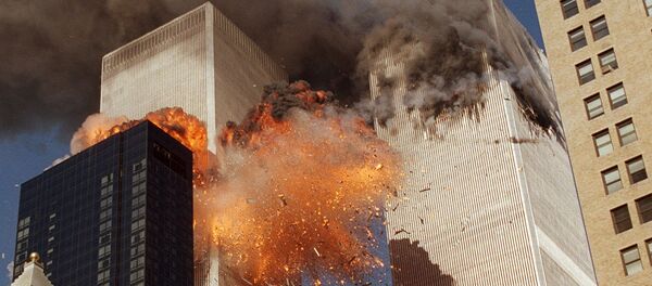 Smoke billows from one of the towers of the World Trade Center and flames and debris explode from the second tower, Tuesday, Sept. 11, 2001 - Sputnik International