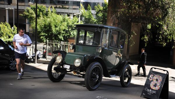 In this photograph taken on September 5, 2012, Bill Lloyd, 61, (obscured) a retired Australian mechanical engineer, patent attorney and vintage car collector sits in his 1915 Detroit electric car out of the garage in Sydney - Sputnik International