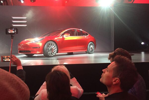 A Tesla Model 3 sedan, its first car aimed at the mass market, is displayed during its launch in Hawthorne, California, March 31, 2016 - Sputnik International