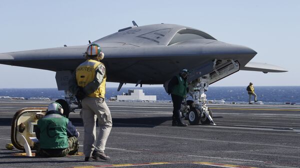 Flight deck crew preparing to launch the X-47B, an experimental unmanned drone aircraft, aboard the USS Theodore Rosevelt, off the coast of Virginia, Sunday, Nov. 10, 2013 - Sputnik International